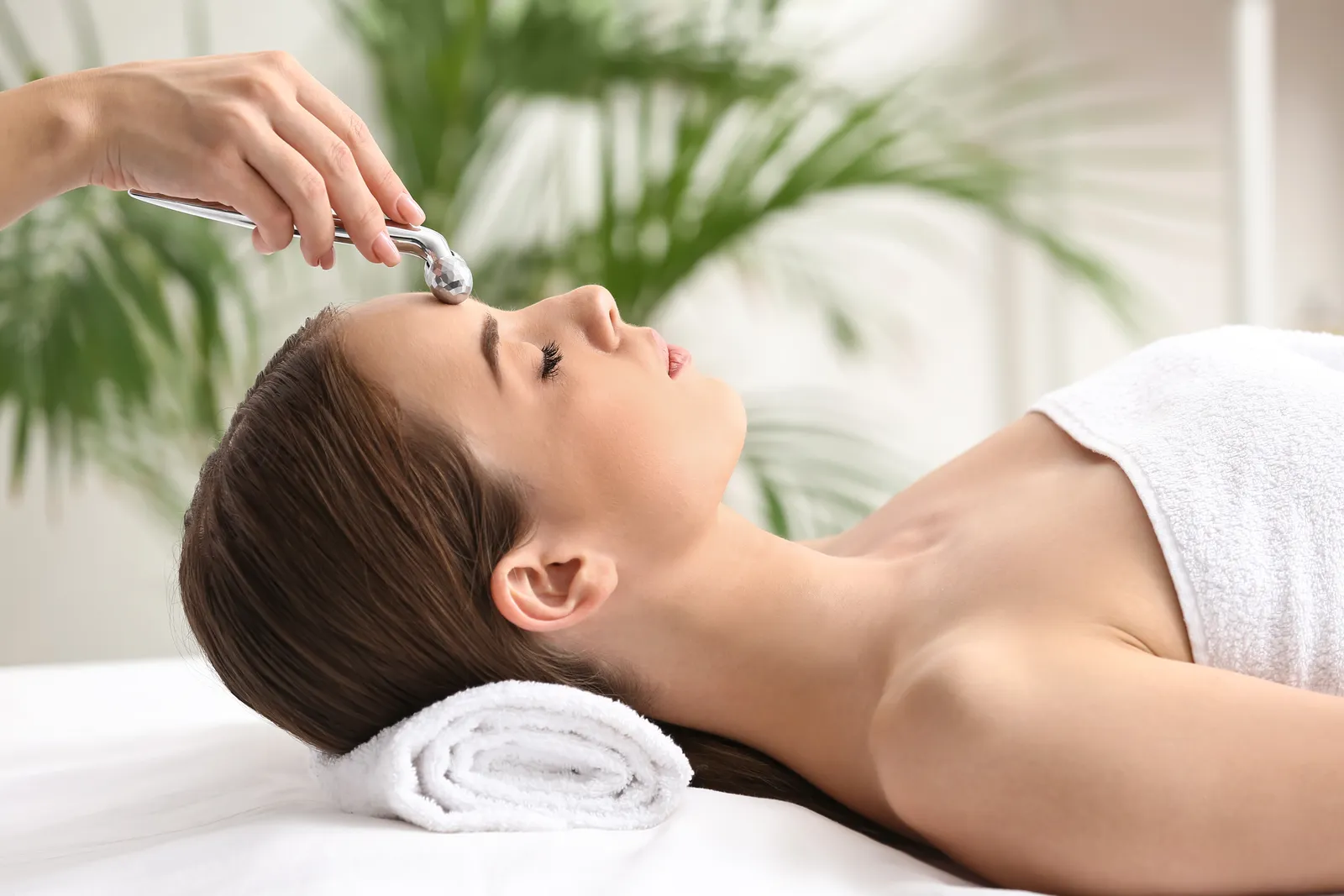 A woman receiving a relaxing facial at Skin Deep Aesthetics