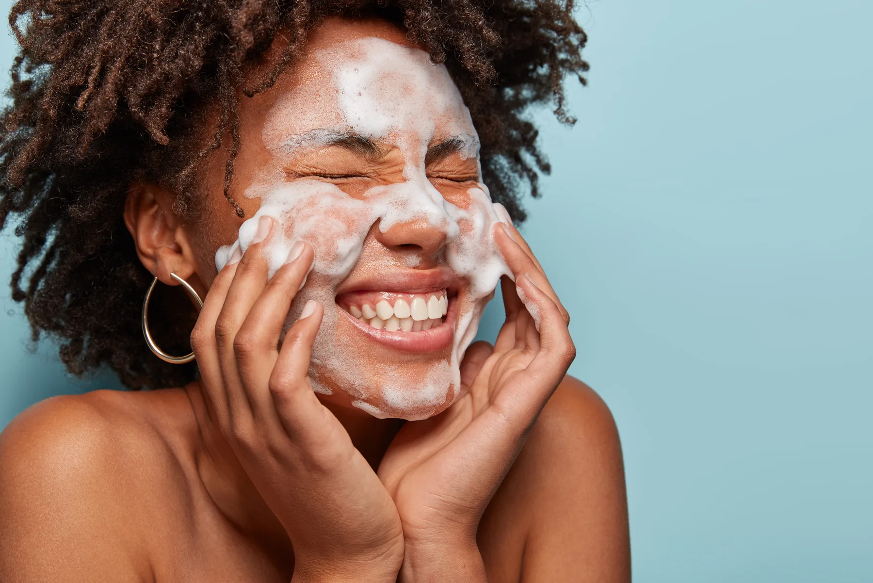 Young teenage girl enjoying a facial cleansing during a teen facial